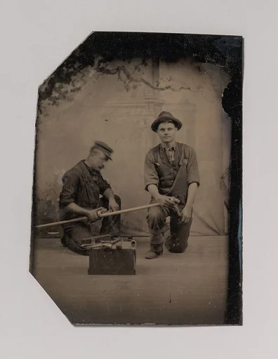 [Two Plumbers with a Pipe, Pipe Cutter, and Toolbox]