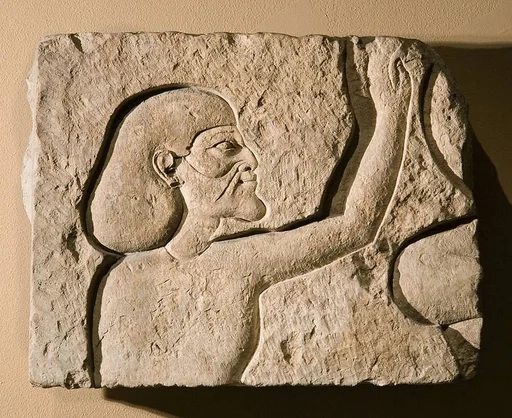 Relief fragment of an Asiatic raising his hands in adoration