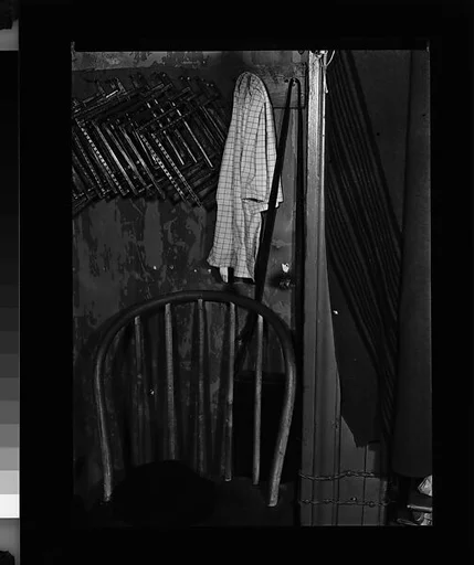 [Walker Evans's Darkroom at 92 Fifth Avenue with Chair, Hat, and Sheet Holders on Rack, New York City]