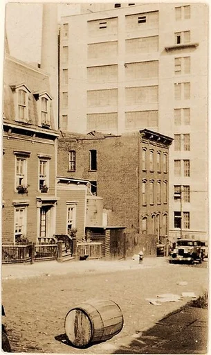 [Exterior View of Apartment Building at 48 Columbia Heights with Barrel in Foreground, Brooklyn, New York]