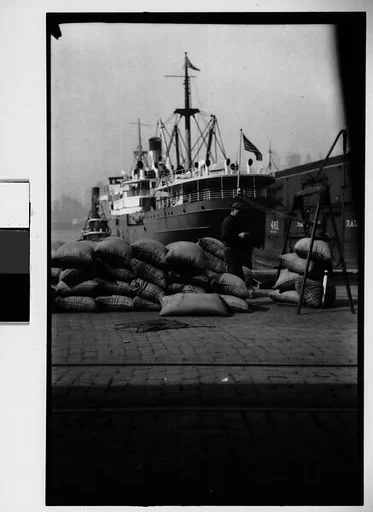 [Stacked Sacks and Docked Ship, New York City]