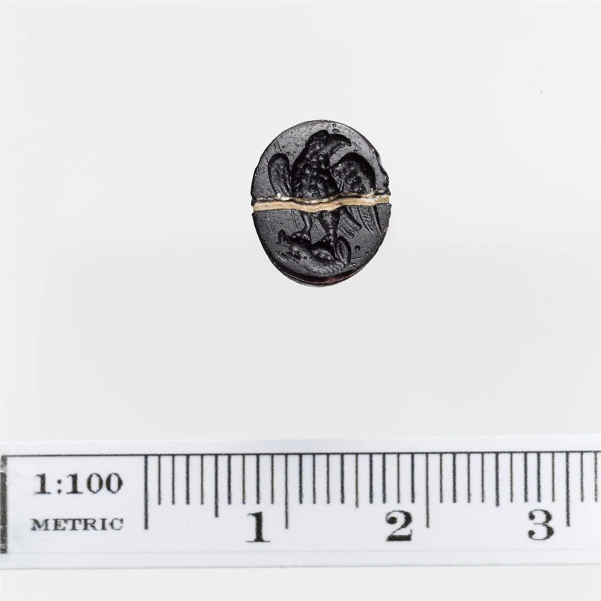 Opaque black glass ring stone with a white band — Unknown