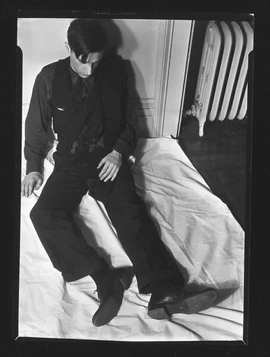 [Walker Evans Seated Upright on Bed, From Above]