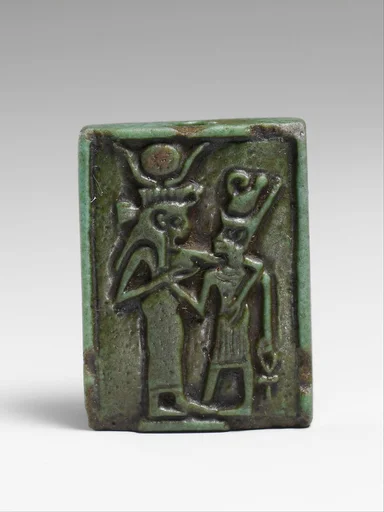 Faience amulet plaque of Isis nourishing a pharaoh