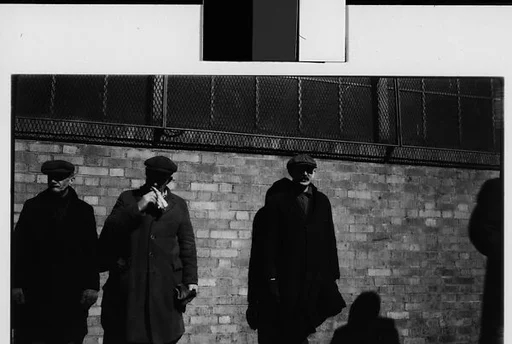 [Men in Hats and Overcoats Standing Against Brick Wall, New York City]