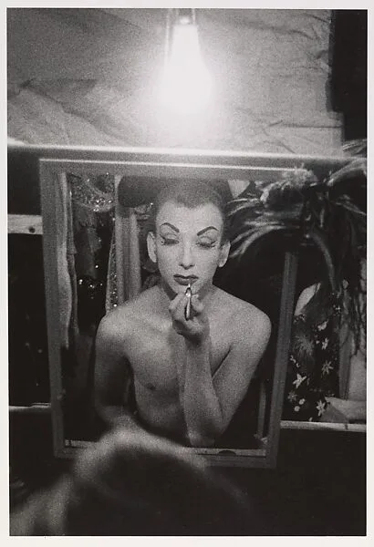 Female impersonator putting on lipstick, Hempstead, L.I. — Diane Arbus