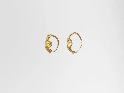 Gold earring with winged figure