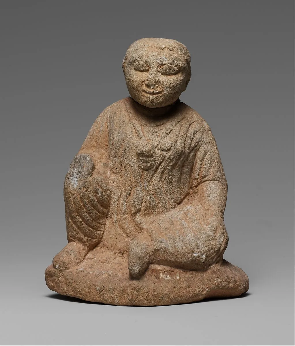 Limestone statuette of a seated temple boy on an inscribed base — Unknown
