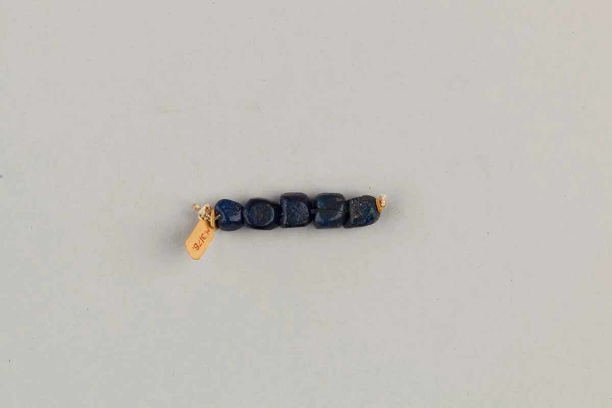 String of 5 four-sided beads — Unknown