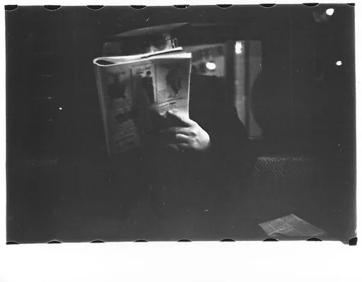 [Five 35mm Film Frames: Subway Passengers, New York City: Man Reading Newspaper, Mother with Book on Lap and Child]