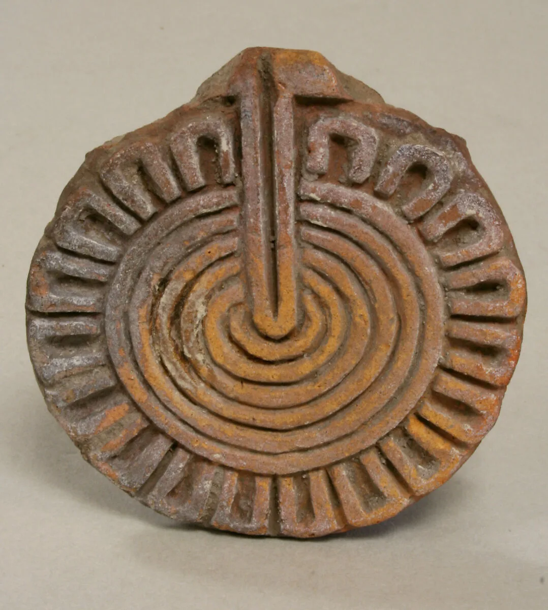 Flat stamp with geometric flower — Unknown