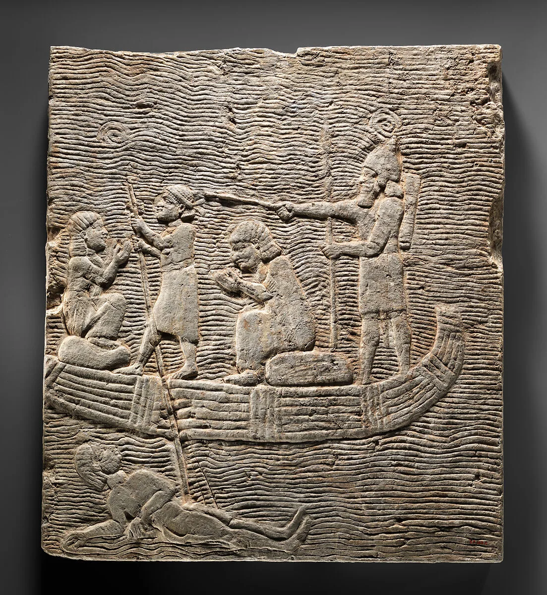 Relief fragment: Assyrian soldier conducting captives across the water — Unknown