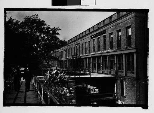 [Two Men on Walkway Across from Warehouse Buildings, Savannah, Georgia]