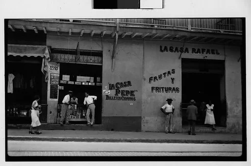 [Street Scene in Front of Lottery Ticket Shop "La Casa Pepe" and Fruit Market "La Casa Rafael", Havana]