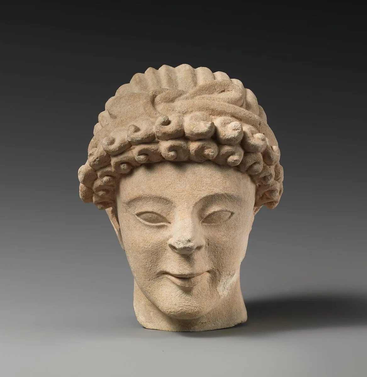 Limestone head of male votary with fillet — Unknown