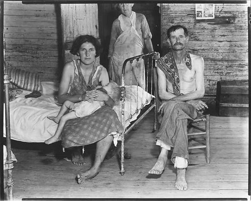 [Bud Fields with His Wife, Her Mother, and Infant Child in Bedroom, Hale County, Alabama]
