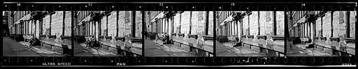 [Five 35mm Film Frames: View Down Street in Hell's Kitchen with Children on Stoop and Torn Circus Posters, New York City]