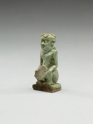 Nude crouching figure wearing a wreath, large phallus broken away