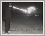 OAKLAND, CALIF. Charles B. Campbell, Washington, D.C., G-Man, is shown demonstrating the use of sub-machine guns to local police at the target range here. This picture, showing Campbell’s accuracy on the target body, was taken with flash bulb lighting in a fraction of a second, yet eight bullet traces are visible, all striking the figure in the chest and stomach
