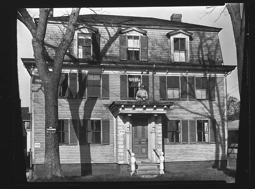 [Greek Revival House with Figurehead Over Entry Porch]