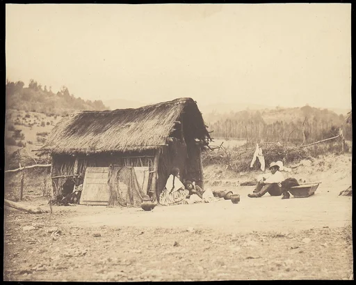 [Family Seated by Thatched Hut, South America]