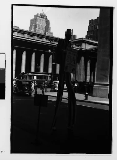 [Two 35mm Film Frames: "Uncle Sam" Sandwich Board Advertiser on Stilts Outside Pennsylvania Station, and Passenger on Bus or Streetcar, New York City]