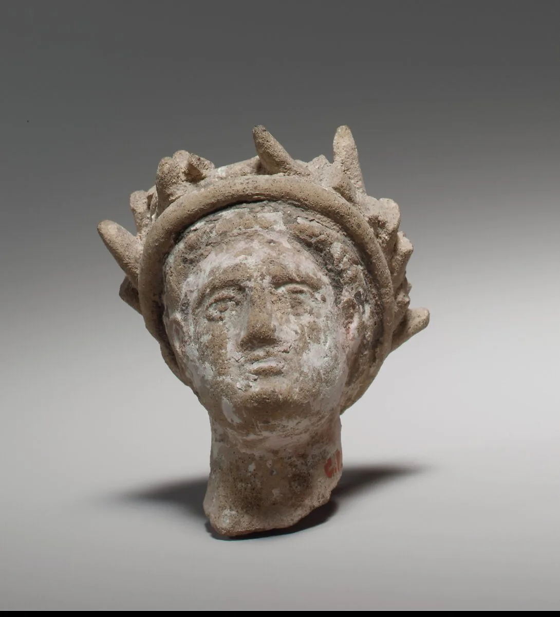 Terracotta male head wearing a wreath — Unknown