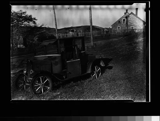 [Junked Roadster with Shingled House in Distance, Cape Cod, Massachusetts]