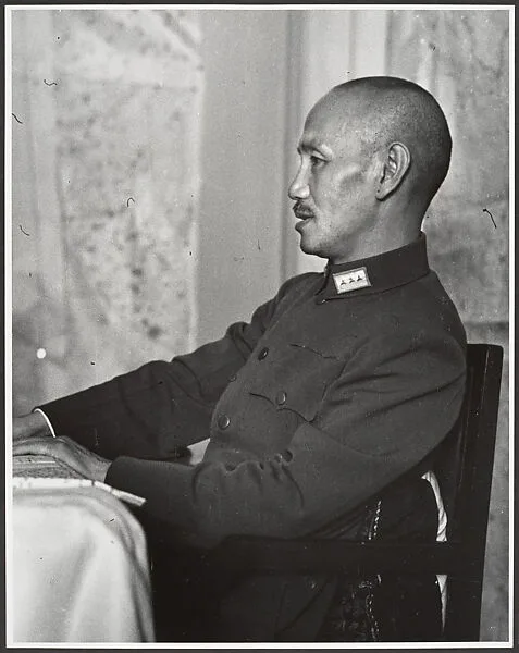 Chaing Kai-shek presides over his Supreme War Council just prior to the departure of the twenty-eight German advisors who had been instrumental in training his army. Hankow, July 4 — Robert Capa
