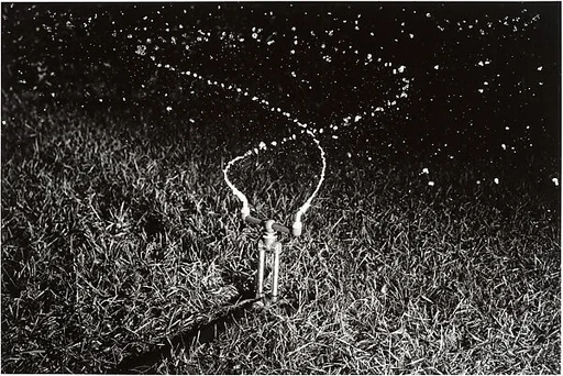 [Rain King Sprinkler Spraying Water at Night]
