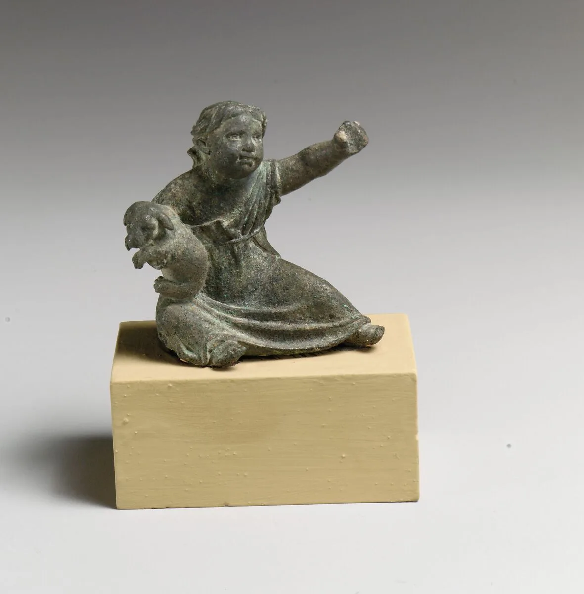 Bronze statuette of a girl holding a dog — Unknown