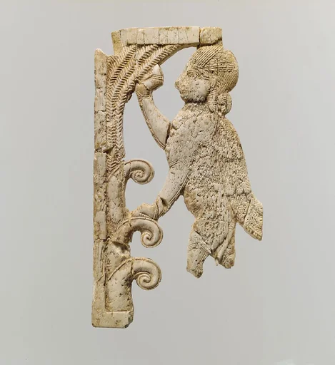 Openwork plaque with a sphinx at a tree