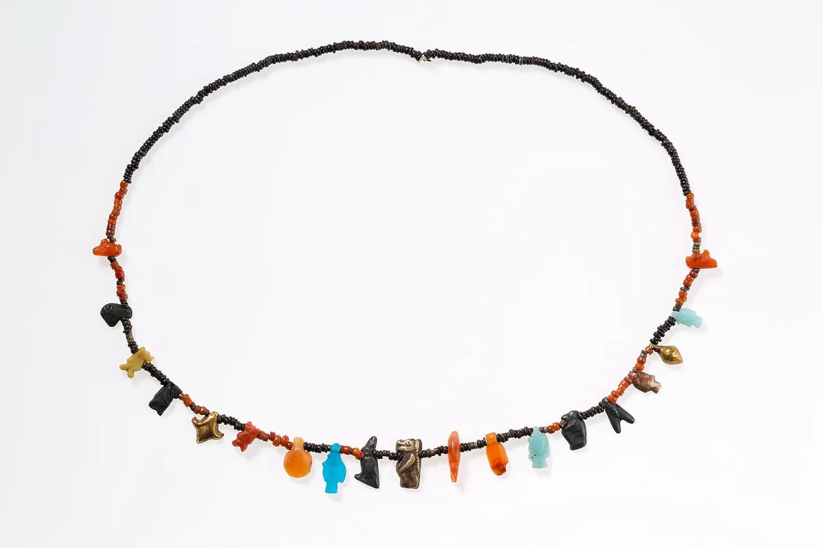 Necklace with disc beads and amulets — Unknown