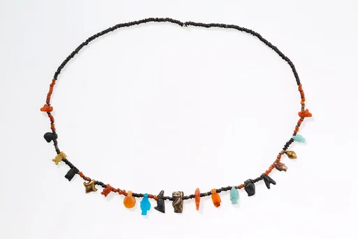 Necklace with disc beads and amulets