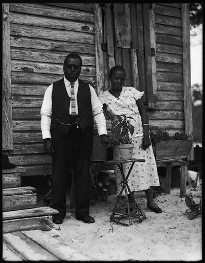 [Man In Rounded Spectacles and Woman Outside House, Florida]