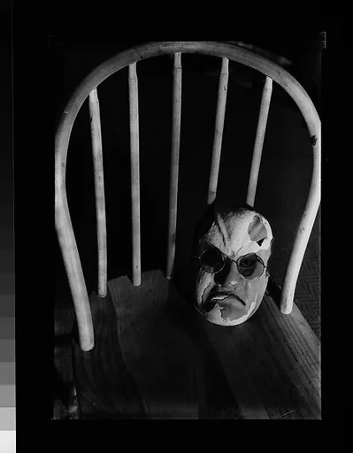 [Japanese Mask with Spectacles on Seat of Chair]