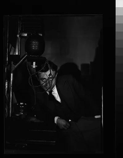 [Hanns Skolle Posed Behind 35mm Negative Enlarger]