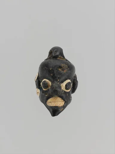 Glass pendant in the form of a demonic mask