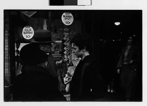 [Two 35mm Film Frames: Man and Two Women in Conversation on Street Outside Newberry's, New York City?]