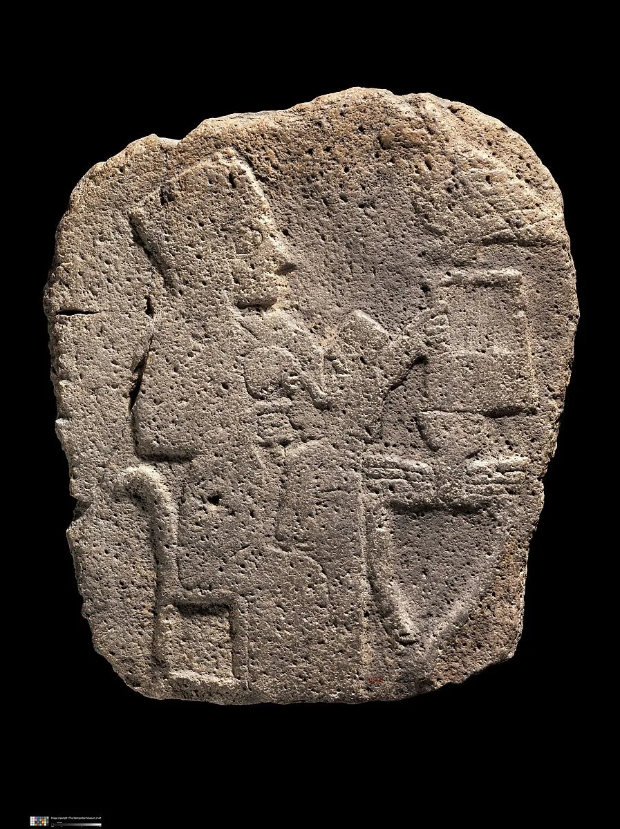 Relief: woman seated at a table — Unknown