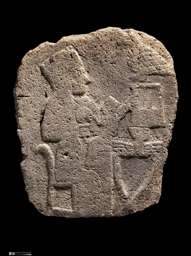 Relief: woman seated at a table