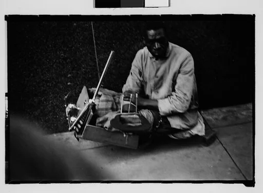 [Legless Man in Dolly on Street, New Orleans, Louisiana]
