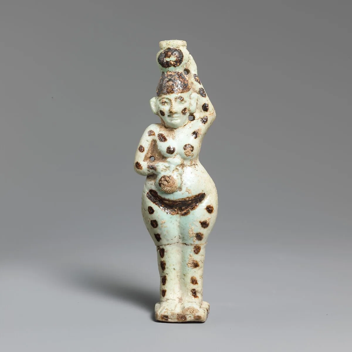 Faience statuette of a woman holding two vases — Unknown
