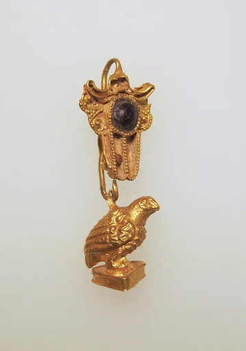 Earring with hawk pendant