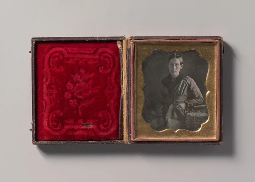 [Young Woman Seated Next to a Table with Elbow Resting on a Book]