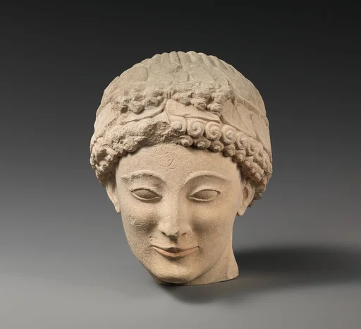 Limestone beardless male head with ivy wreath
