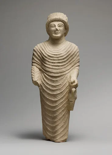 Limestone statue of a male votary holding a bird in the left hand