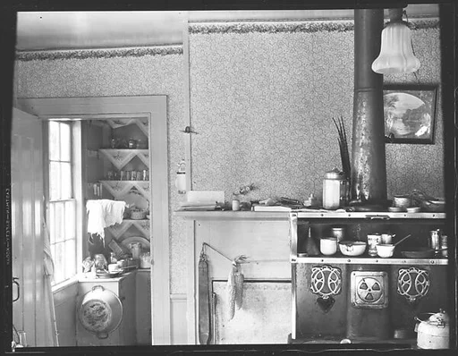 [Kitchen Interior Showing Stove and Doorway to Pantry]