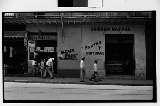 [Street Scene in Front of Lottery Ticket Shop "La Casa Pepe" and Fruit Market "La Casa Rafael", Havana]