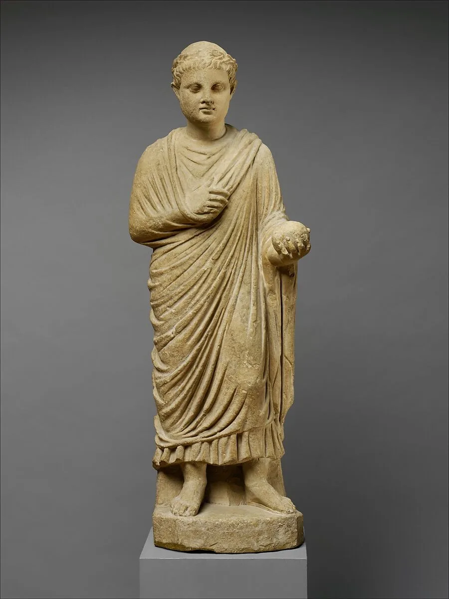Limestone statue of a wreathed boy holding a ball or piece of fruit — Unknown